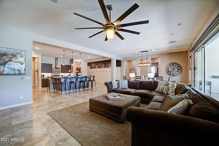 large ceiling fan and oversized granite island with seating for 6