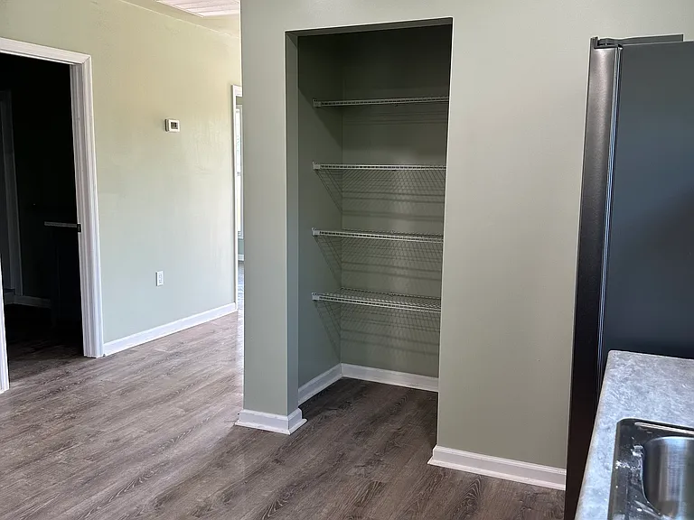 Large eat in Kitchen with Pantry for convenient storage for small appliances.