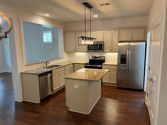 Granite topped kitchen island with room for seating
