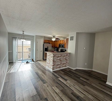 Looking into the front door...Living room, Easting Area to the left of Kitchen OR around kitchen counter. Blinds are hiding patio door to back yard.