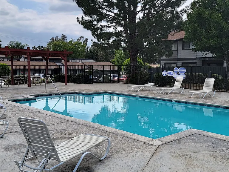 Swimming pool and sun deck at Dove Ridge Apartments in Riverside, CA.