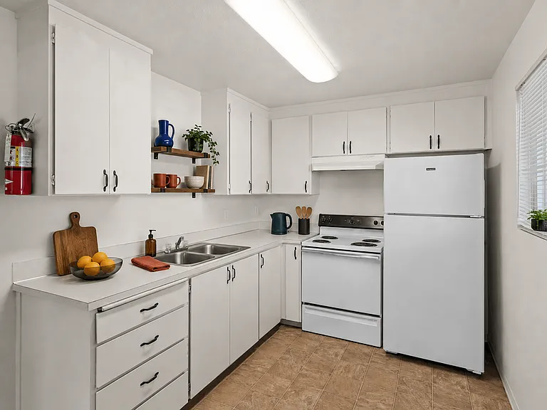Bright, functional kitchen with plentiful cabinet storage and full-size appliances at Palisades Apartments in Tacoma.