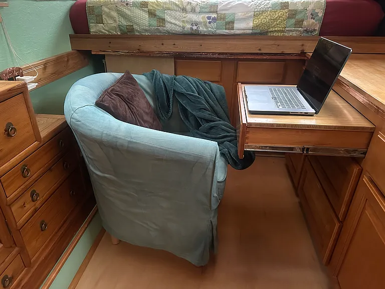 The comfy chair can be pulled around and the tabletop added to the drawer to create a little workspace.