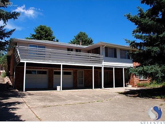 Back of the house with walkout deck from master bedroom and sun room. Also, a walkout from basement 