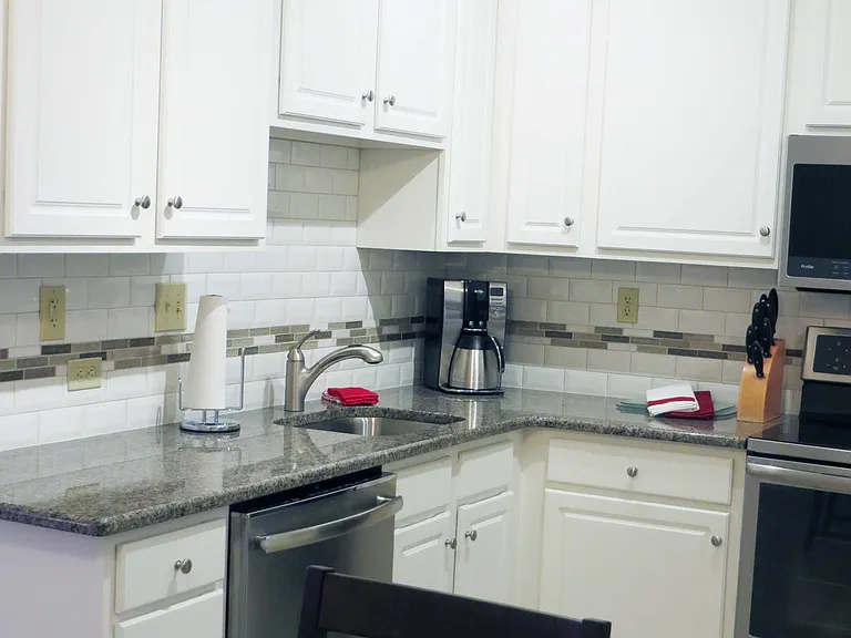 42" White kitchen cabinetry and upgraded stainless steel appliances.