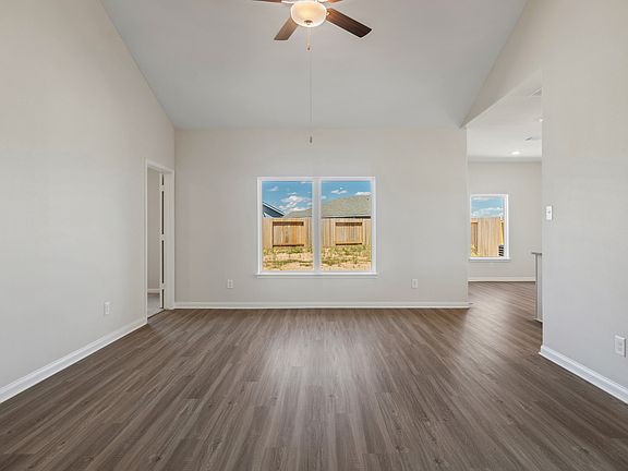 The living room is spacious and has a large window.