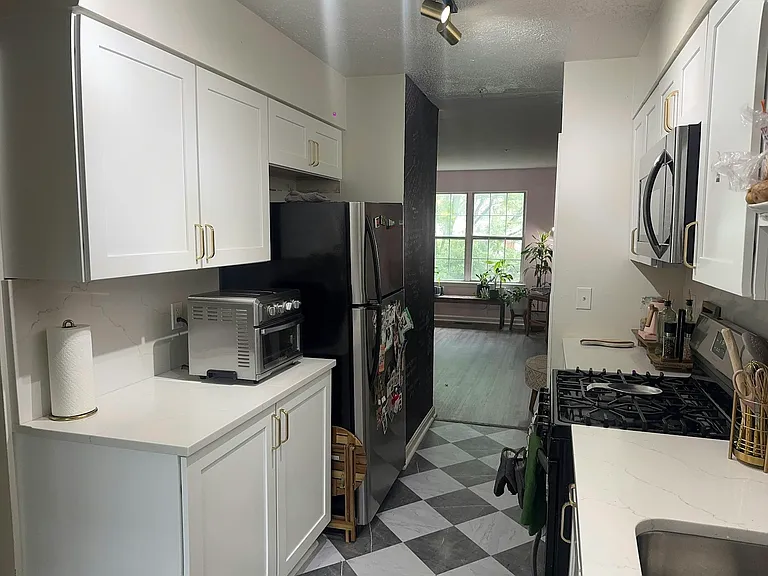 Gallery kitchen with standard refrigerator