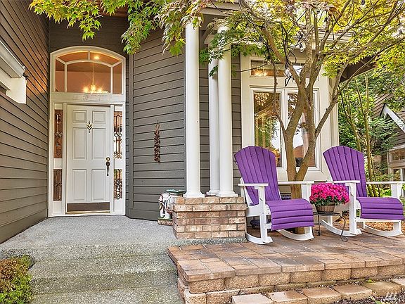 Inviting Entryway Includes A Stone Patio Area And A Leaded Glass Door.