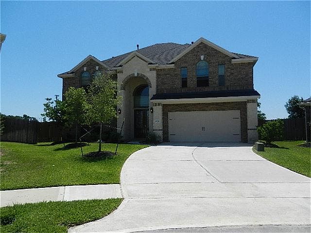 FRONT ELEVATION WITH STONE AND BRICK.