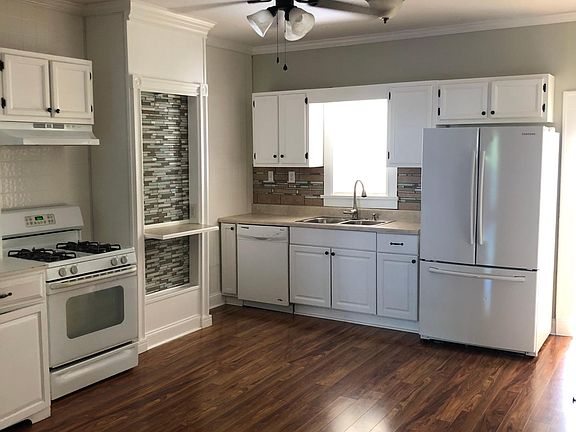 Kitchen with sunroom and laundry behind it