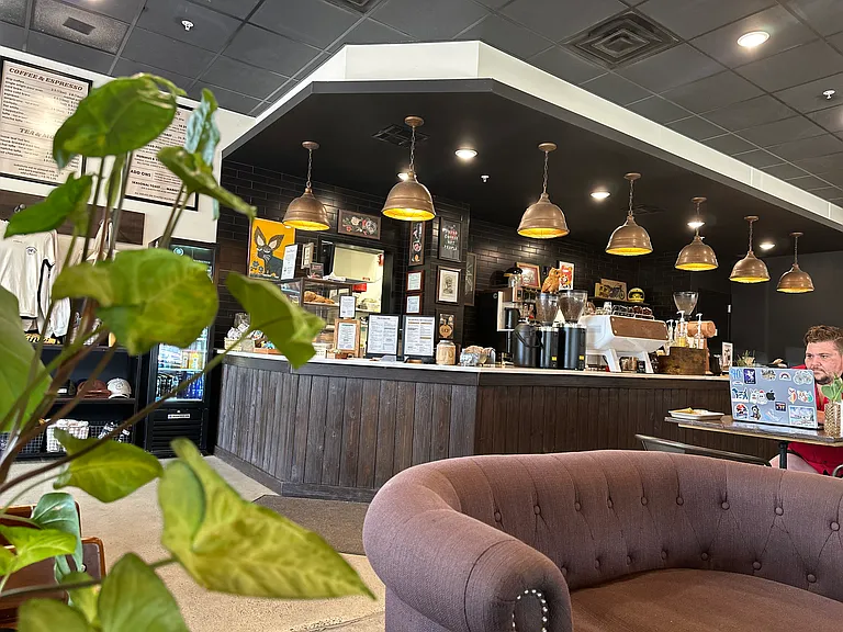 Steps away from a top-rated cafe offering artisan barista service and freshly roasted, in-house coffee.