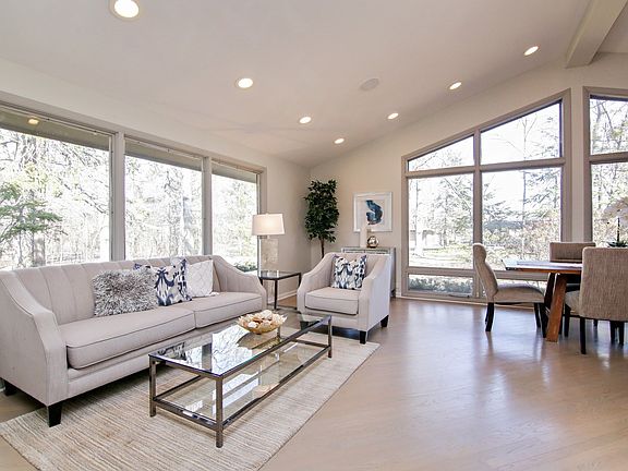 Living/dining area with cathedral ceiling and an abundance of natural light