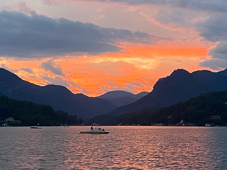 Stunning Lake Lure sunset looking up Hickory Nut Gorge toward Chimney Rock State Park where you can have some incredible hikes.