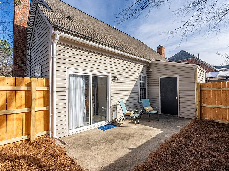 Exterior patio area with new privacy fence and exterior storage closet for your use.