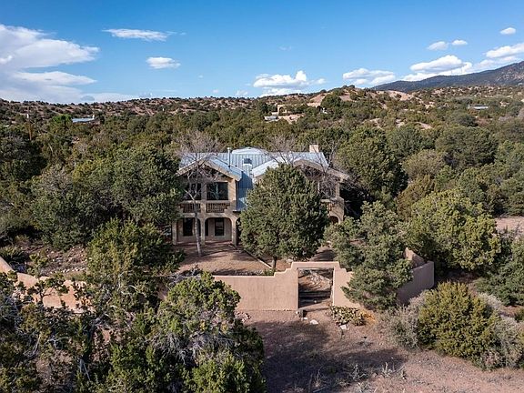 Aerial view of the back side of the house before most of the trees were trimmed back