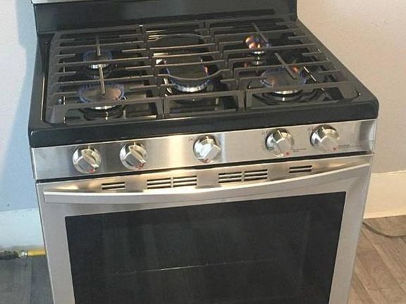 Gas stove provided in kitchen.