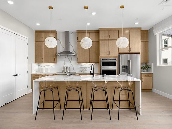 Kitchen with large central island and a waterfall edge countertop
