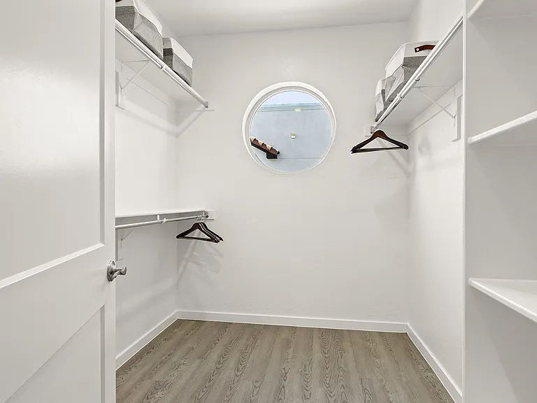 Large walk-in closets with wooden floors