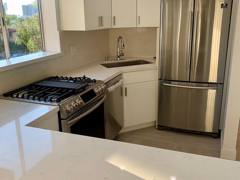Remodeled kitchen with quartz counters, custom cabinets and stainless steel appliances