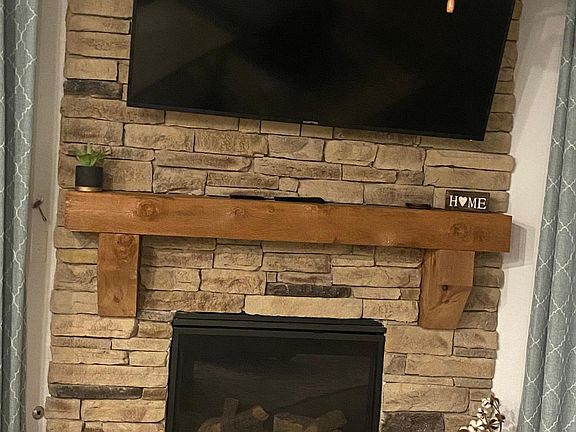 Stone fireplace. Tv will remain with the new tenants