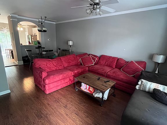 The red couch and dining room table will not be in the home, but a different couch will replace it.