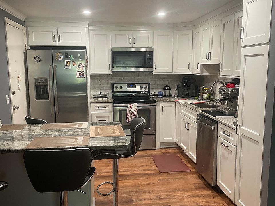 This is a similiar unit. 91Pleasant street will have the same marble table, countertops but the cabinets will be light gray and the floor will have a more rustic look.