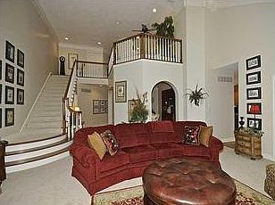 Two story great room showcases the lavish staircase and open loft.
