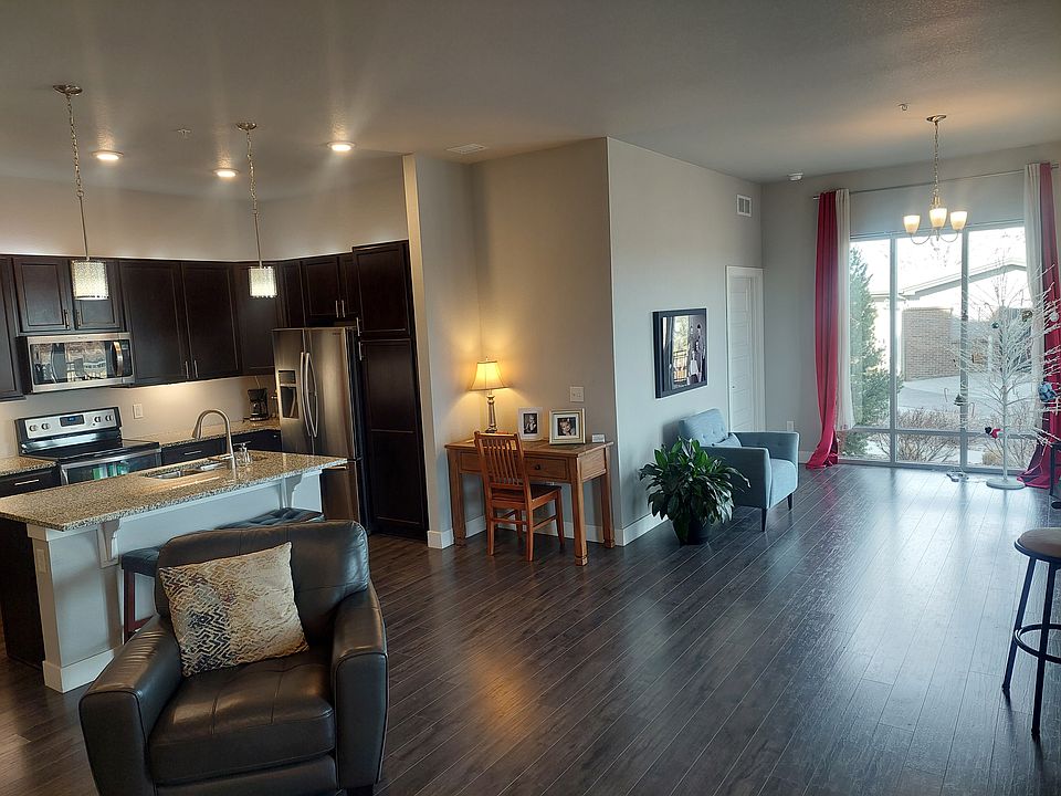 Looking from living room at kitchen and entryway from outside door.