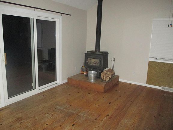 Living room with wood burning stove and deck