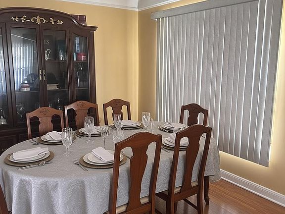 Dedicated dining area with a full-size table, ample seating, and a china cabinet for additional storage and display.