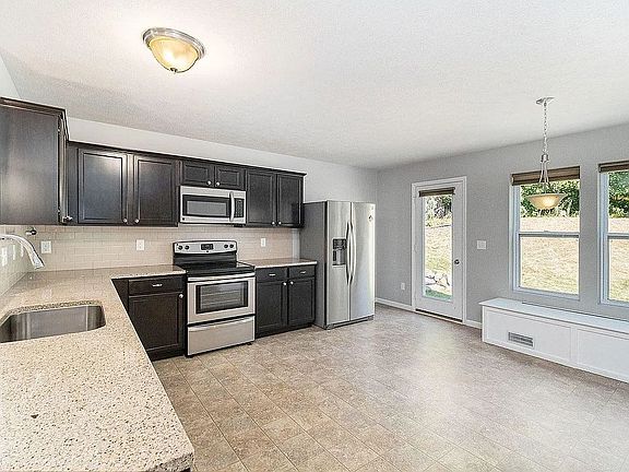 Large kitchen with room for dining table along built-in wall bench (plus storage)