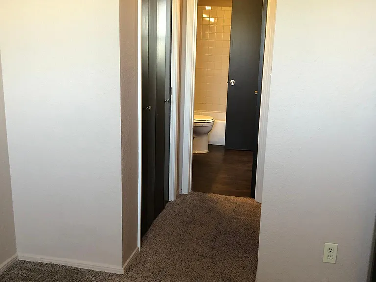 Second bedroom closet and hallway to shared bathroom