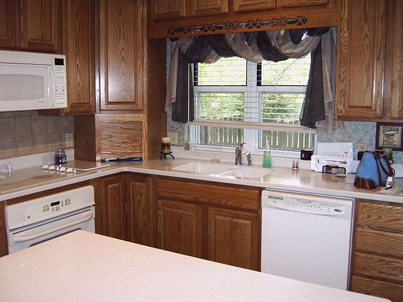 Custom wood cabinets in updated eat-in kitchen