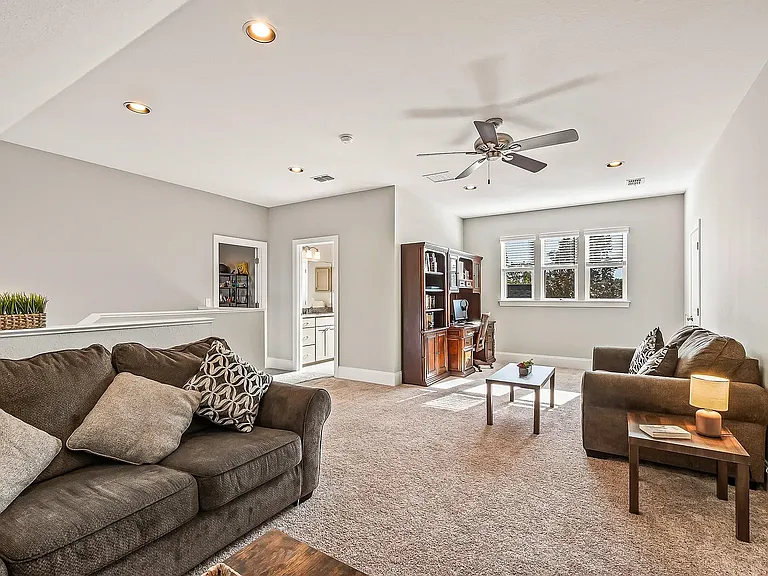 Upper stairs family room and office. View to full bathroom with a bathtub.