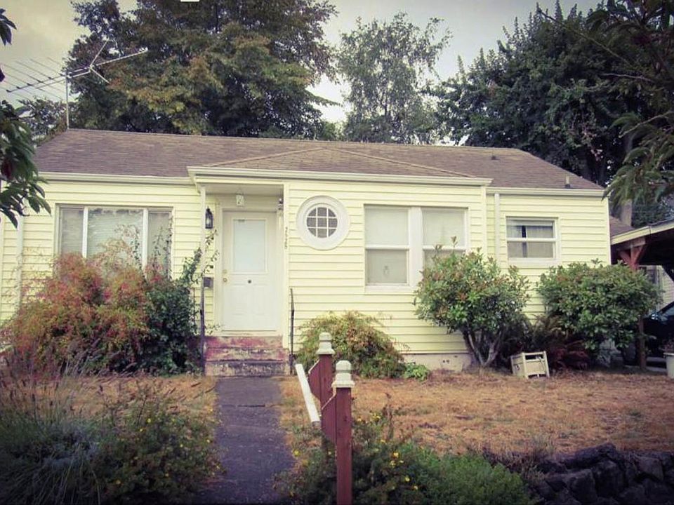 House from the street, landscaping has been trimmed.