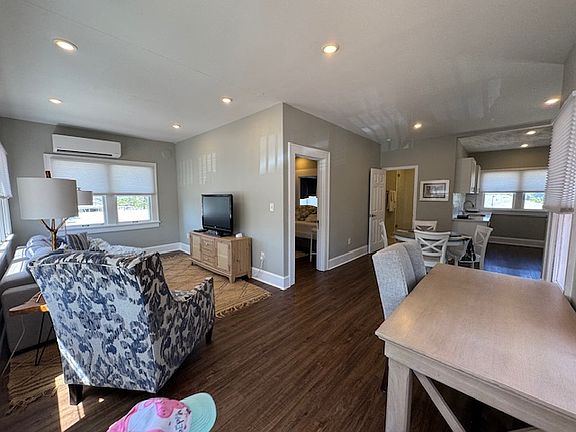 Corner view of open living and dining and kitchen area. Also includes a large Ballard House desk with loads of natural light!