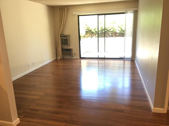 Well lit living room with hardwood floors