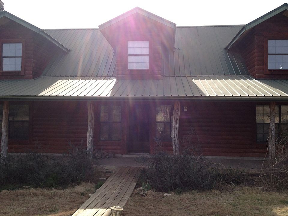Log cabin home with 2 bedrooms upstairs separated by breeze