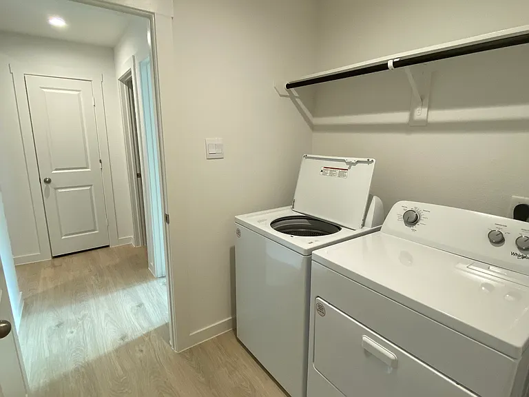 Laundry room, coat closet, half bathroom, and guest bedroom 3 doors visible in back of picture