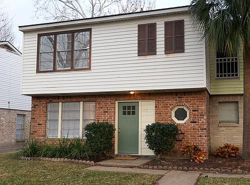 New landscaping and paint warm the entry to the home