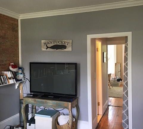 A hallway connects the living room and the bedroom
