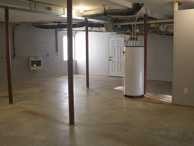 Lower Level Bonus Space: Large partially finished room with a full bathroom and full-size egress window. Ideal as a guest area, home office, gym, studio, hobby space, or optional fourth sleeping area.