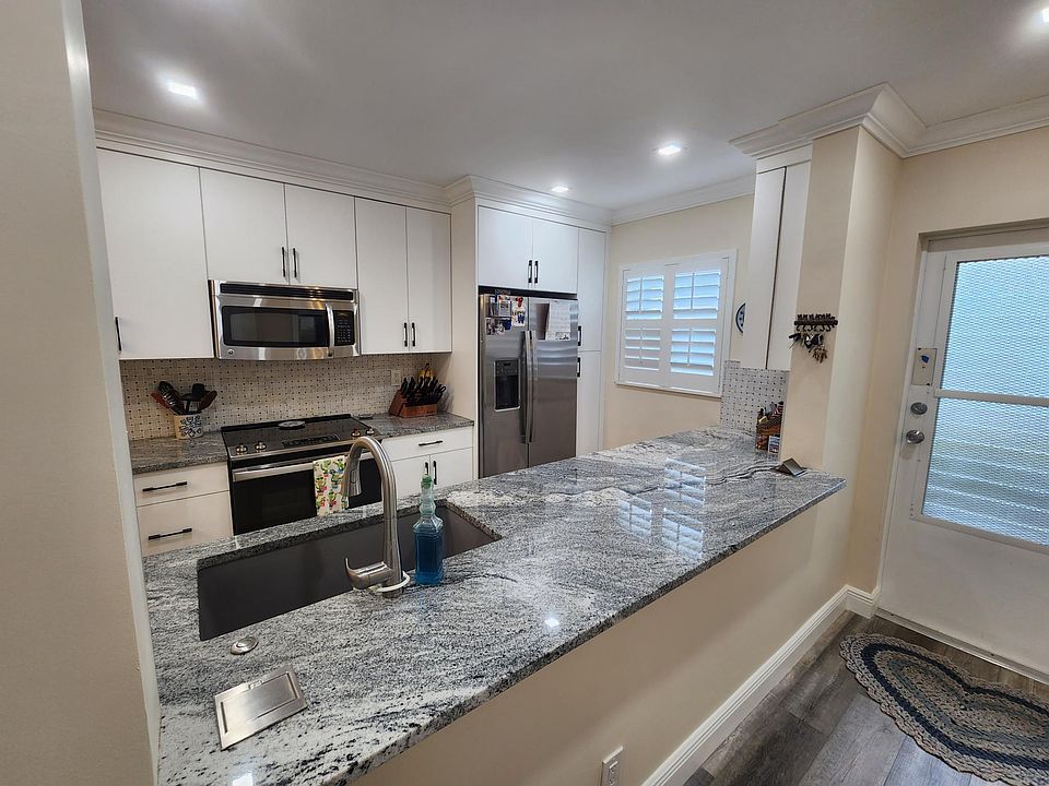 Kitchen looking to entry door.