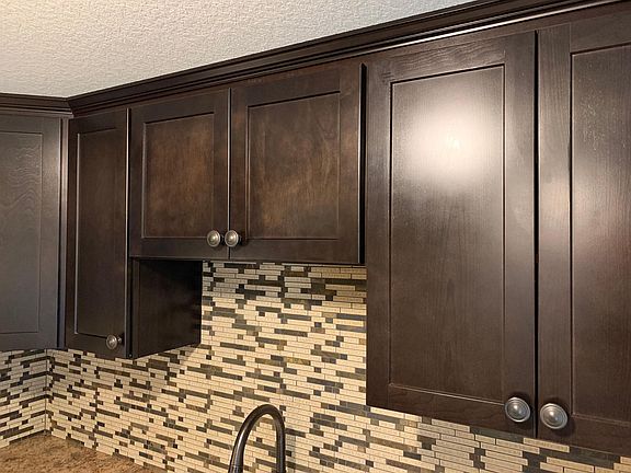High-end wood cabinets and full tile backsplash.