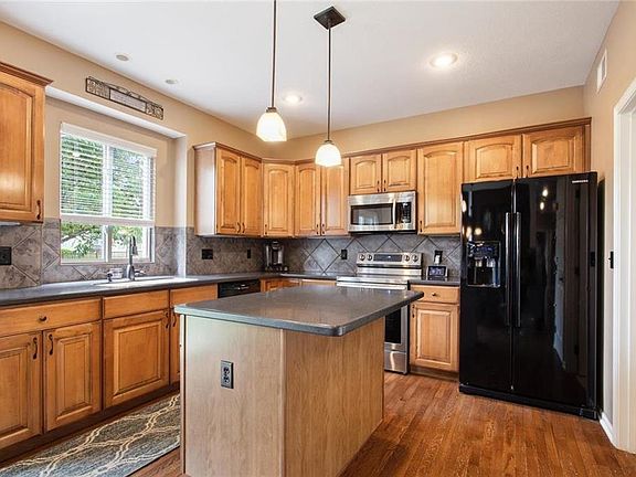 large kitchen with new appliances.