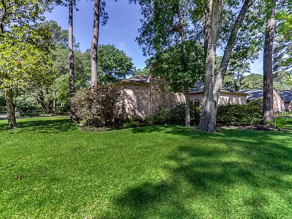 This view is of the corner of the property showing the mature trees, large lot and 3-car driveway on left. Beautiful!