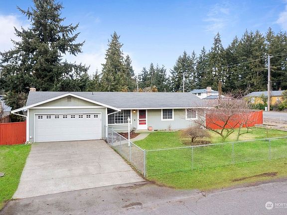 Large fenced and landscaped corner lot with ample space for RV parking.>