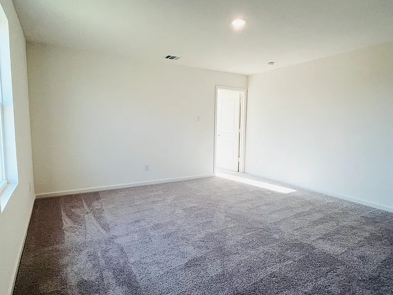Loft with door to primary (master) bedroom