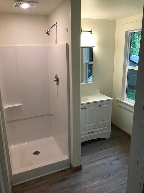 Completely remodeled bathroom. New shower, vanity , flooring, walls, lighting, and windows.