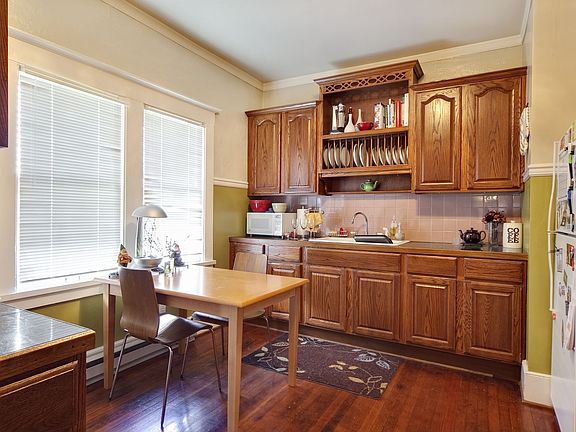 Main level unit kitchen with original fir floors.